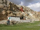 Tibet Kailash 06 Tirthapuri 10 Lhakhang and Cave Near the base of the ridge at Tirthapuri is a temple with a cave behind. Shiva�s lingam is in the background.